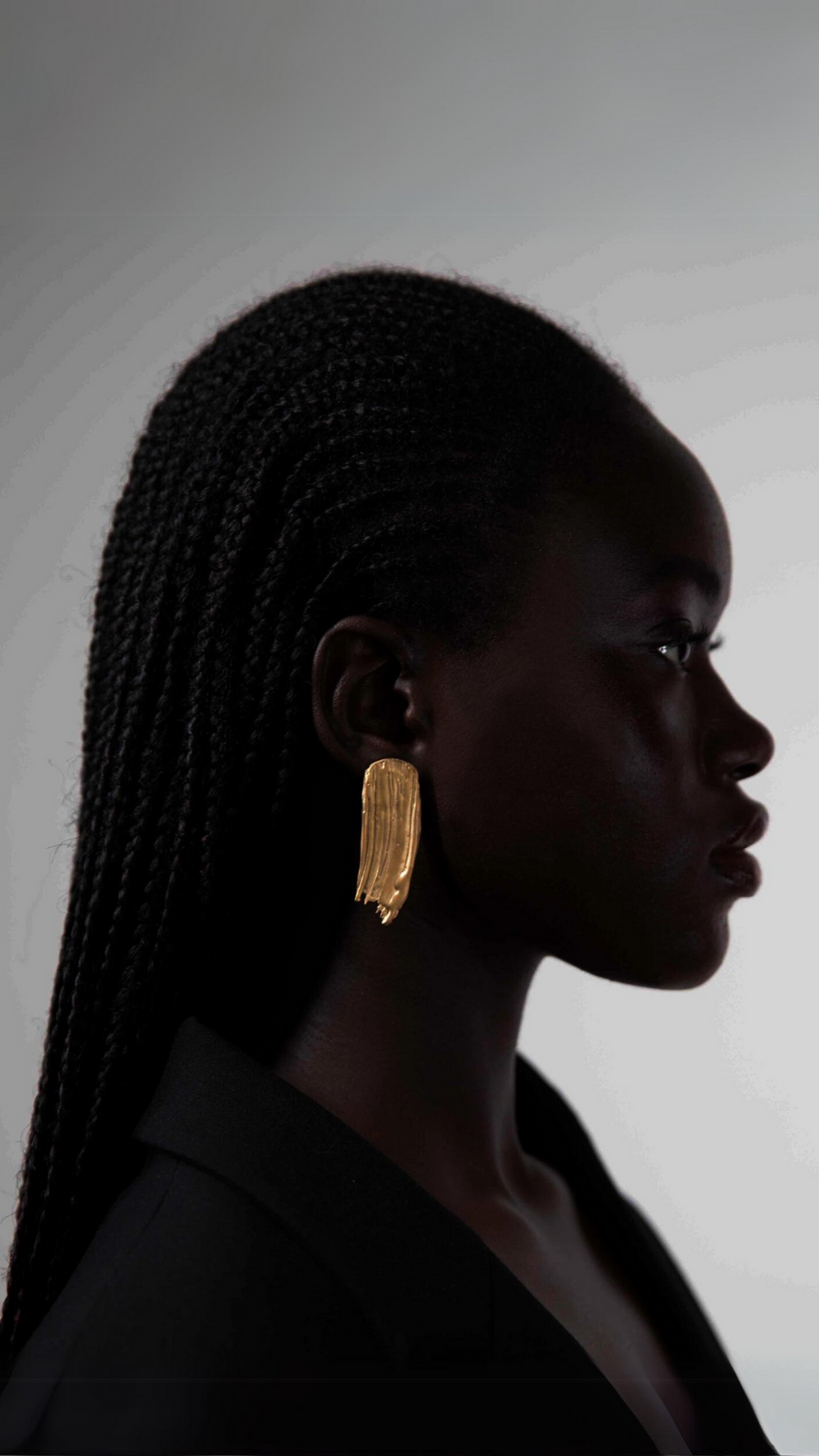 handcrafted gold earring looking like a paint stroke work on ear