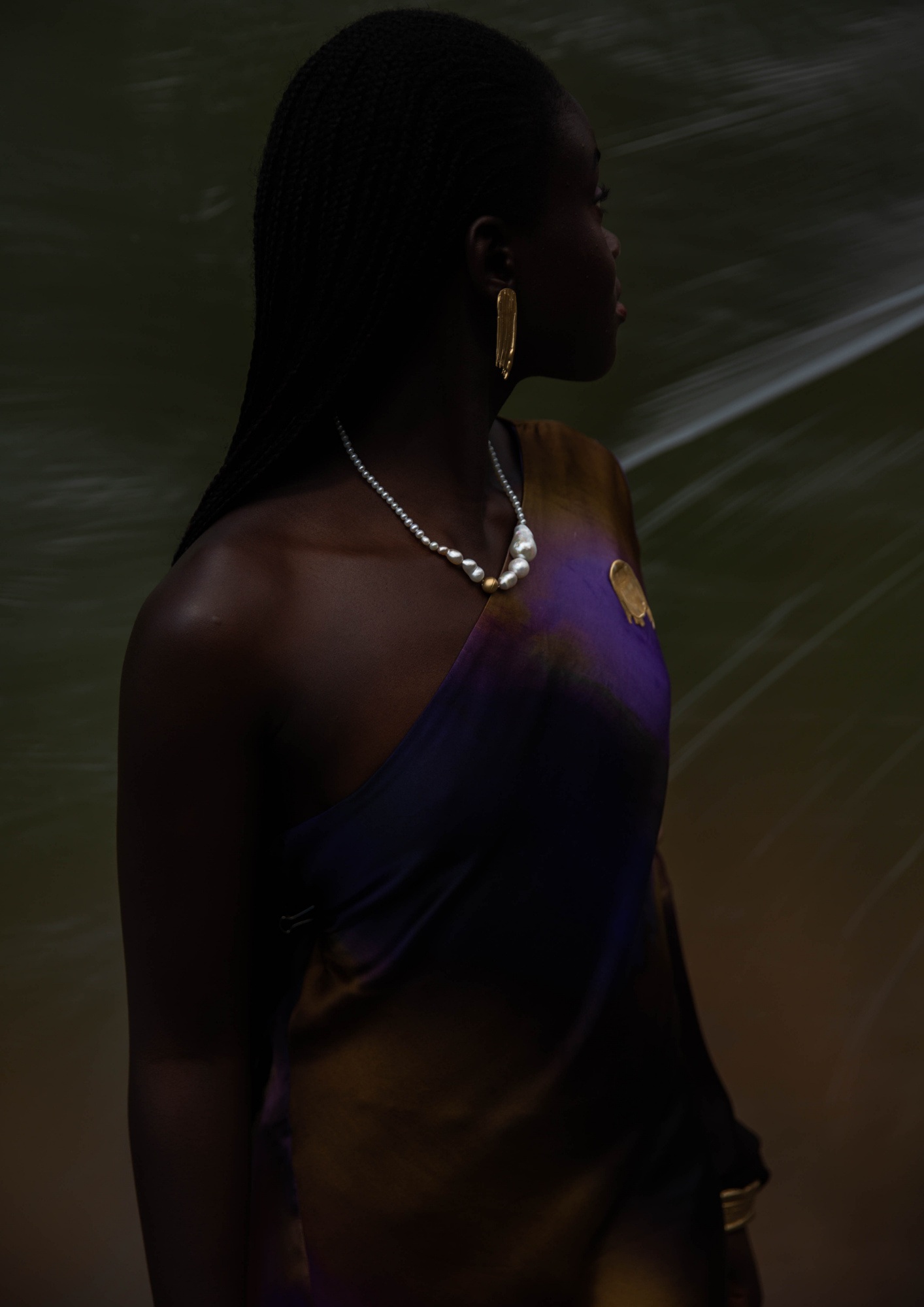 Handcrafted Pearl Necklace worn by model with a blue and gold dress.