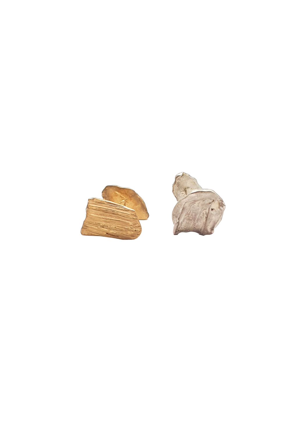 Handcrafted cufflinks in silver and gold on white background