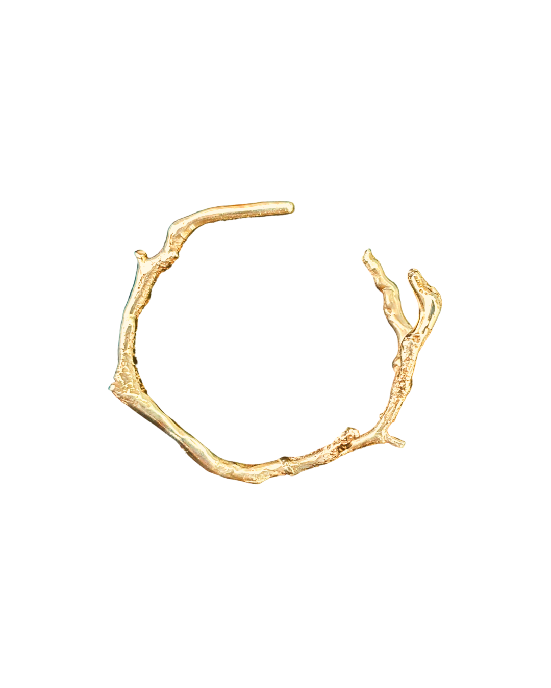 Handcrafted Gold branch-like bracelet on a white background