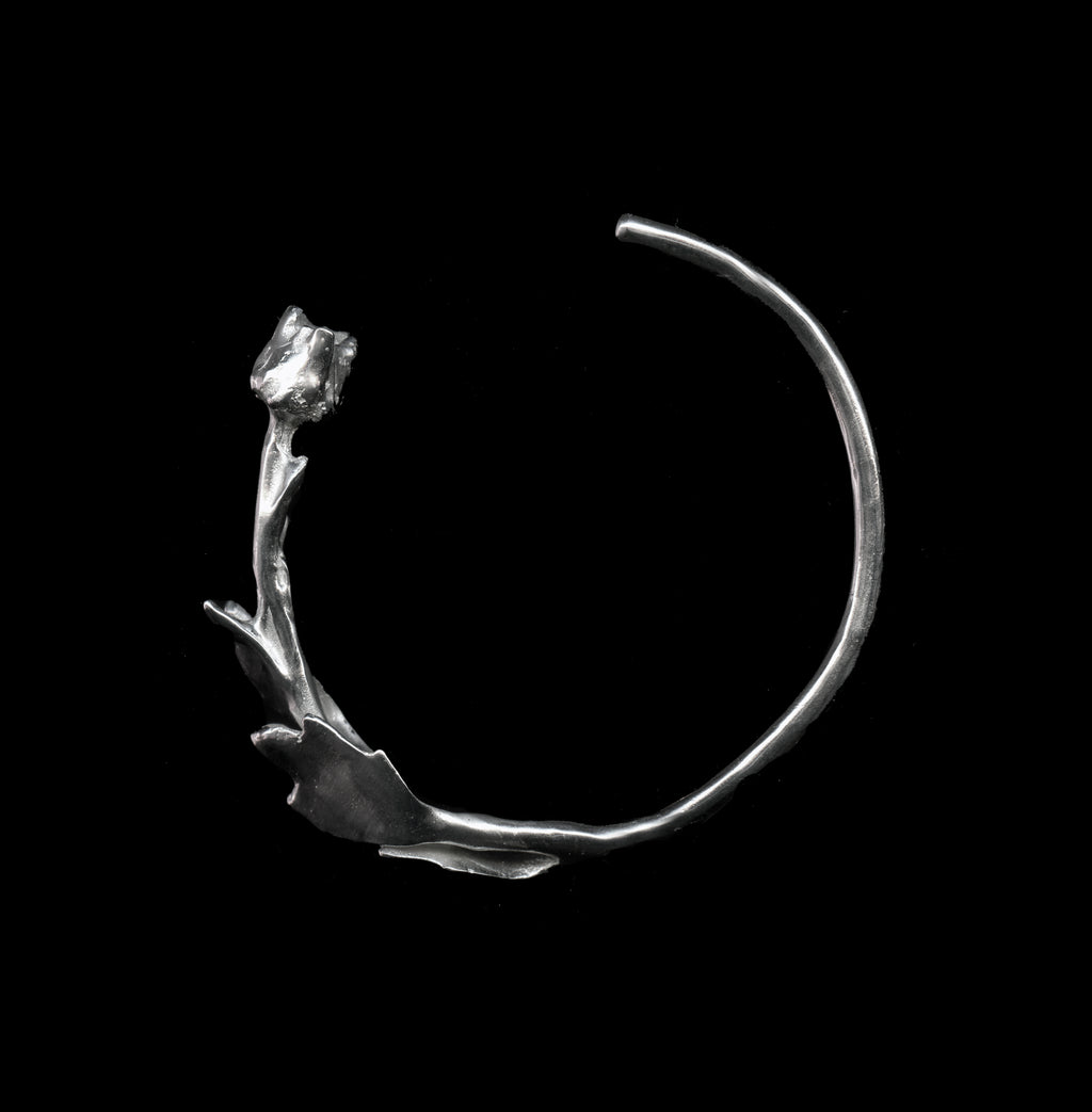 Silver Hancrafted floreo bracelent on black background