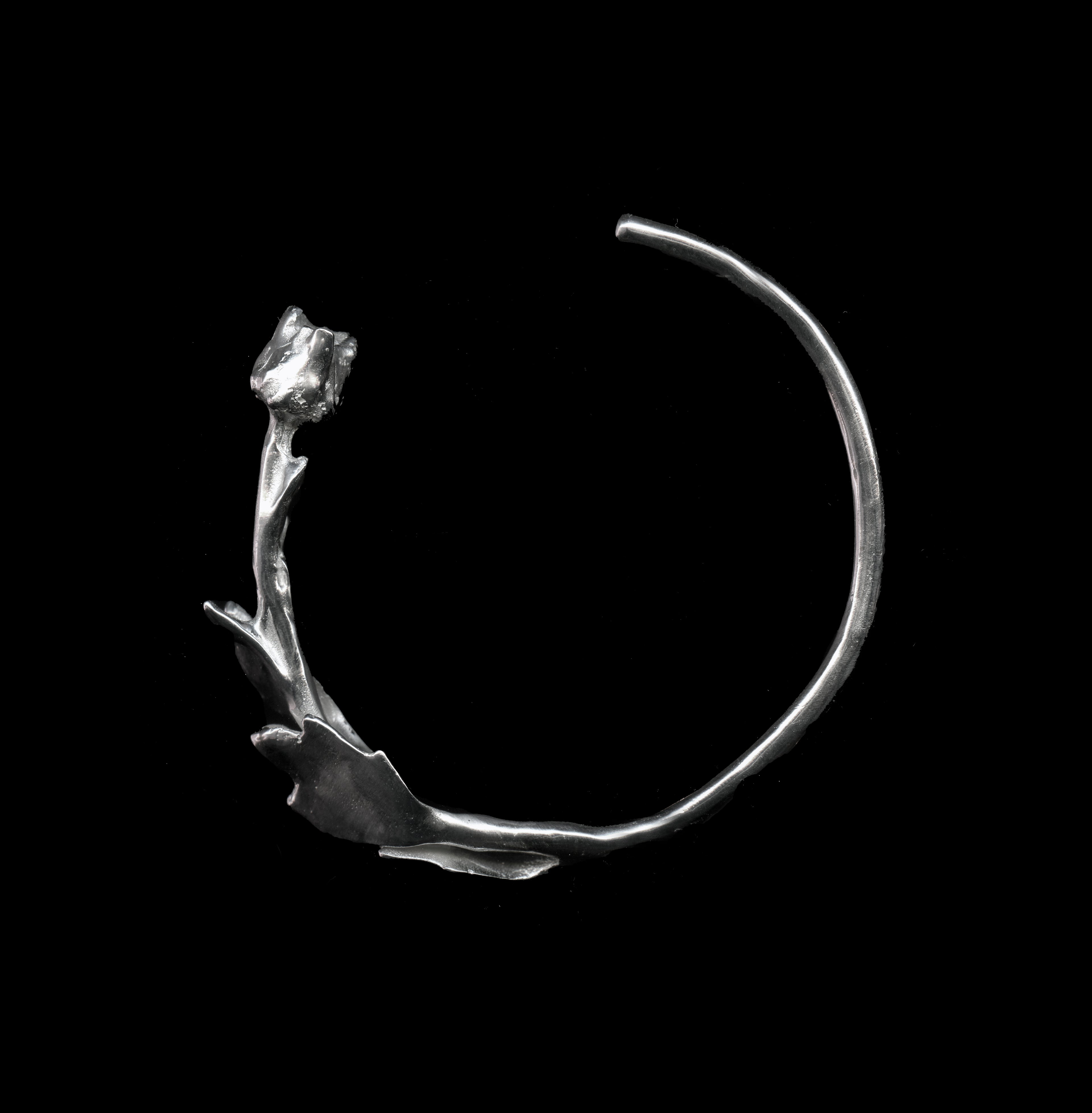 Silver Hancrafted floreo bracelent on black background