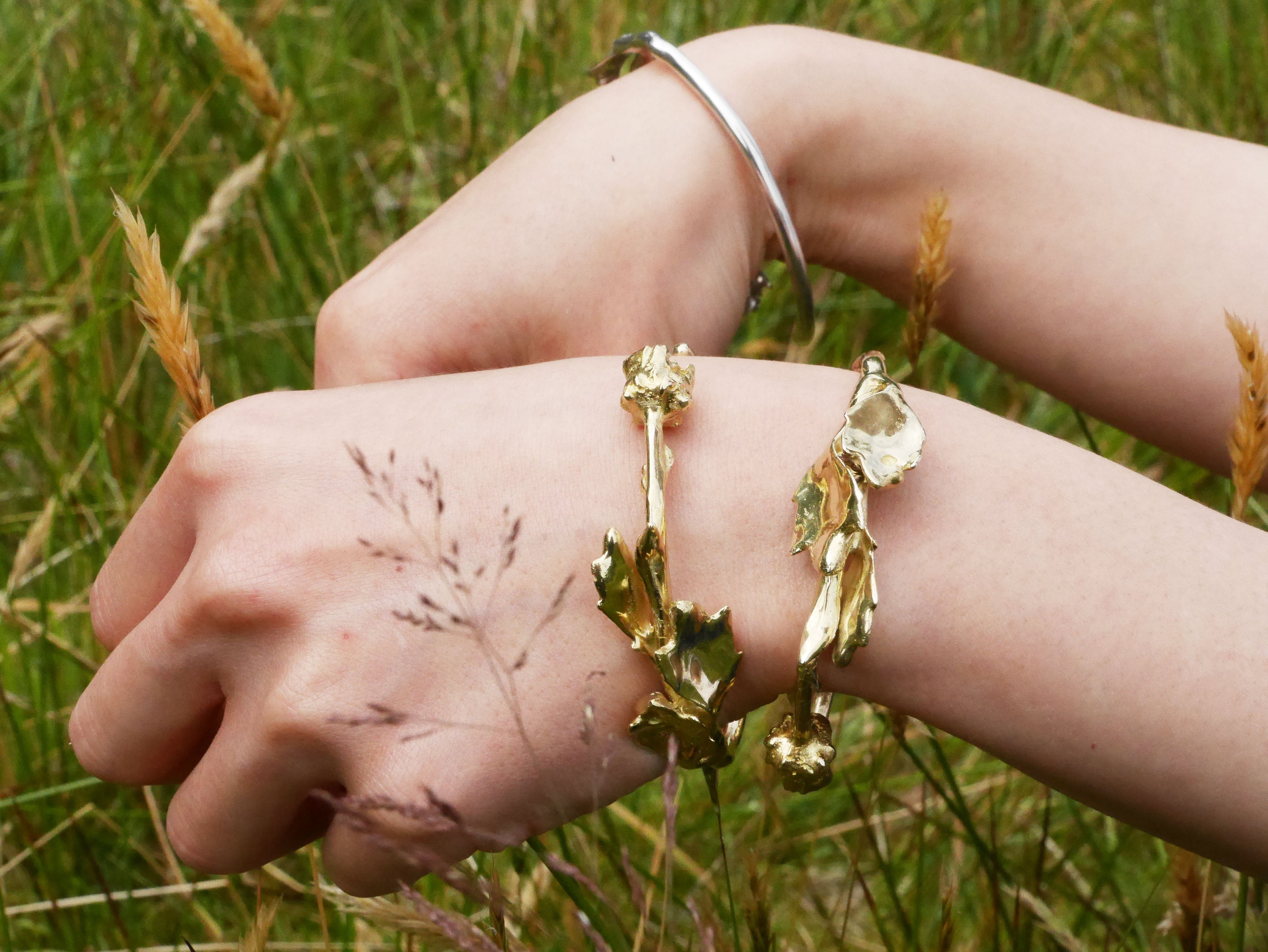 Gold handcrafted floreo bracelet on nature background