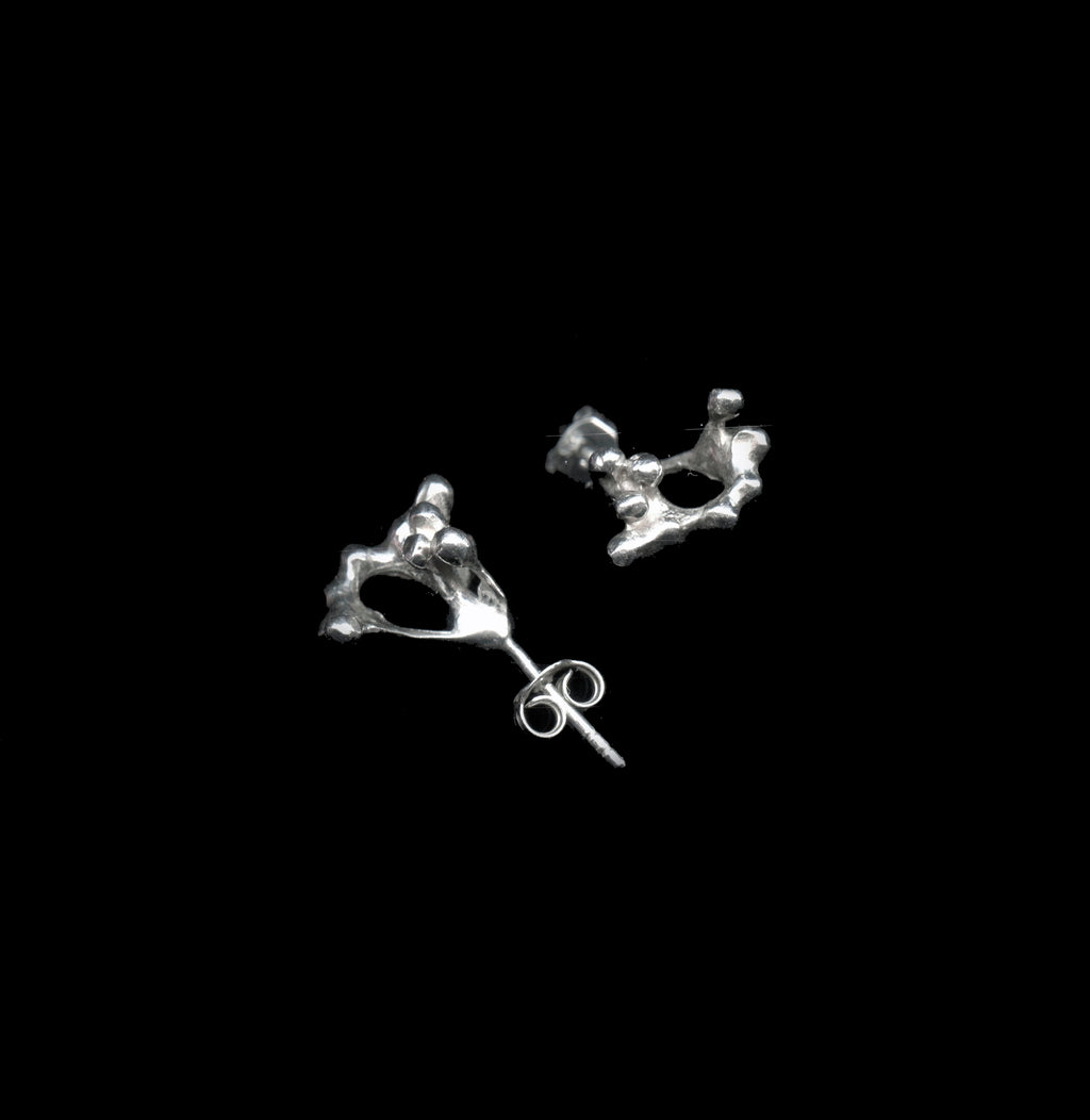 handcrafted Rubella earrings in silver on black background