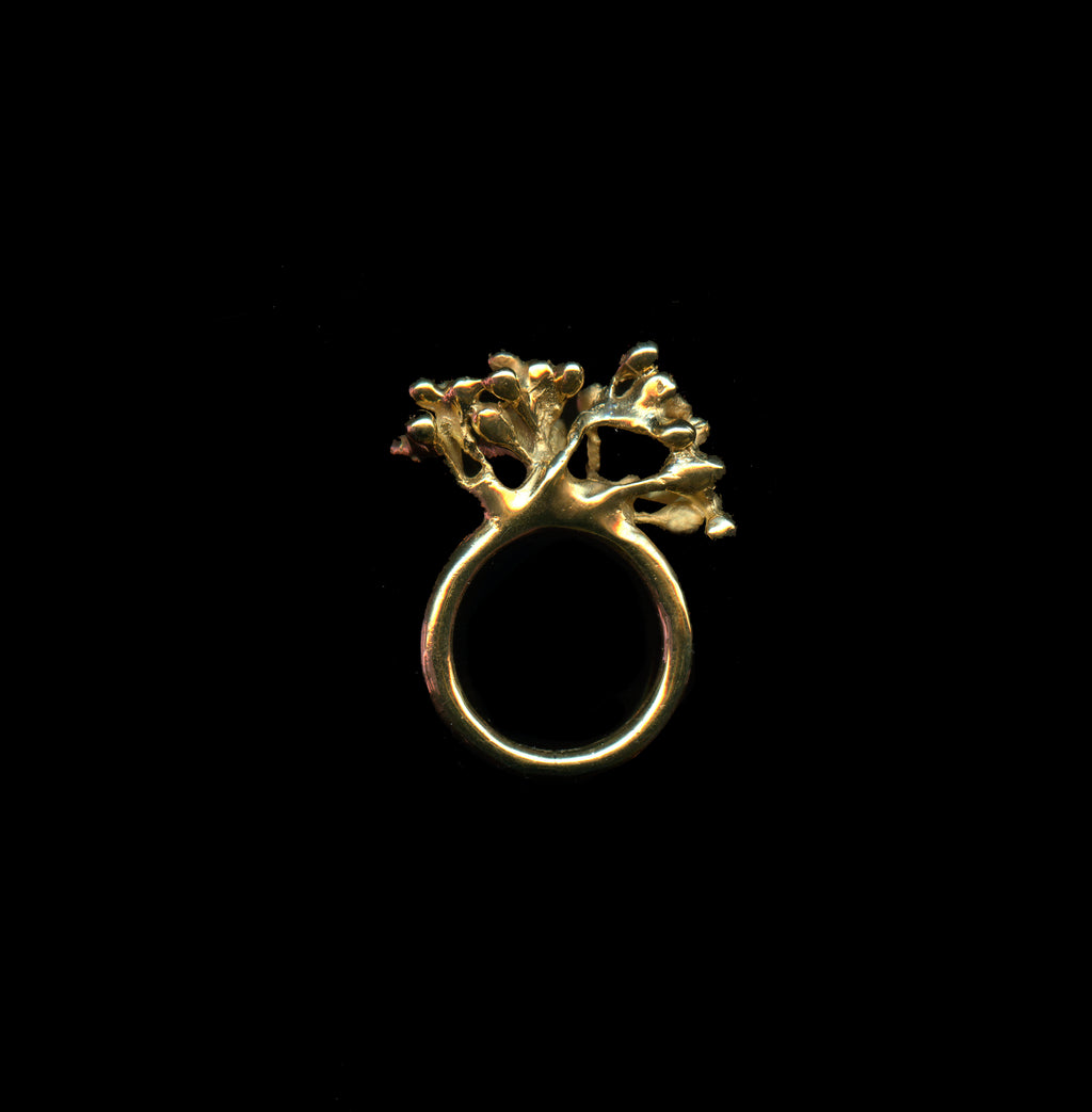 Handcrafted Gold ring with floral design on a black background