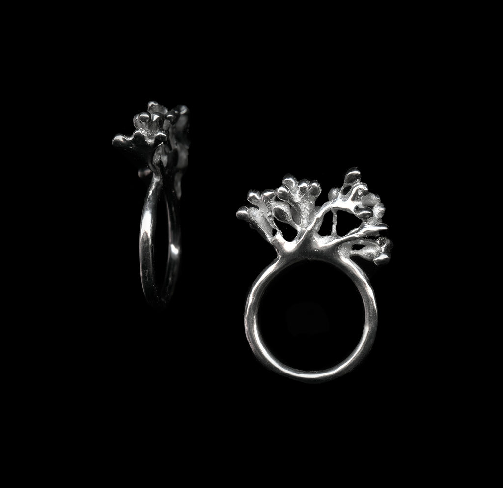 handcrafted silver rubella ring on black background