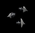 Three handcrafted silver thorn brooches on black background