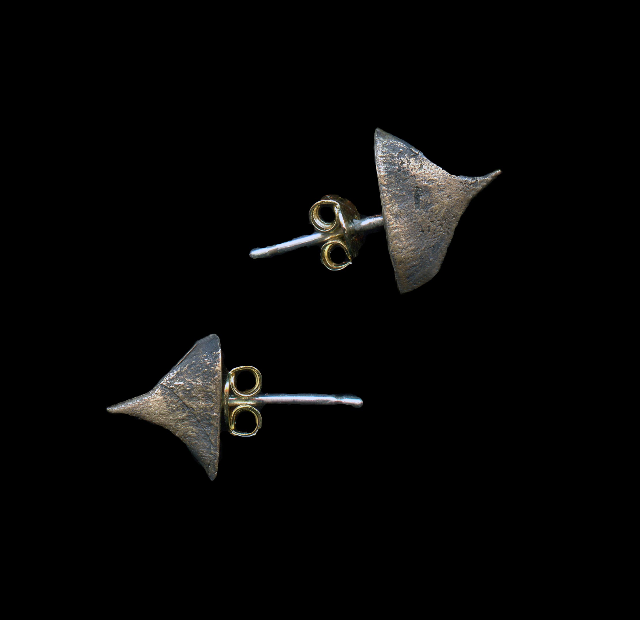 handcrafted thron earrings in bronze on black background