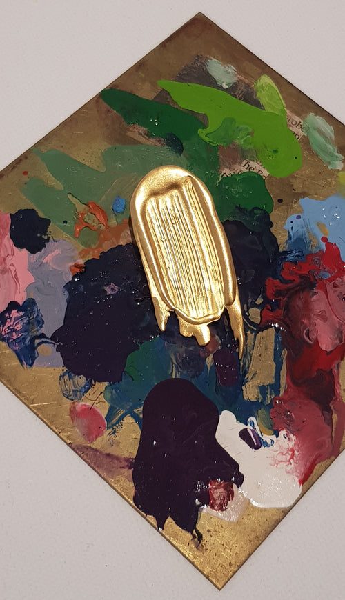 Handcrafted gold brooch looking like a paint stroke on paint palette