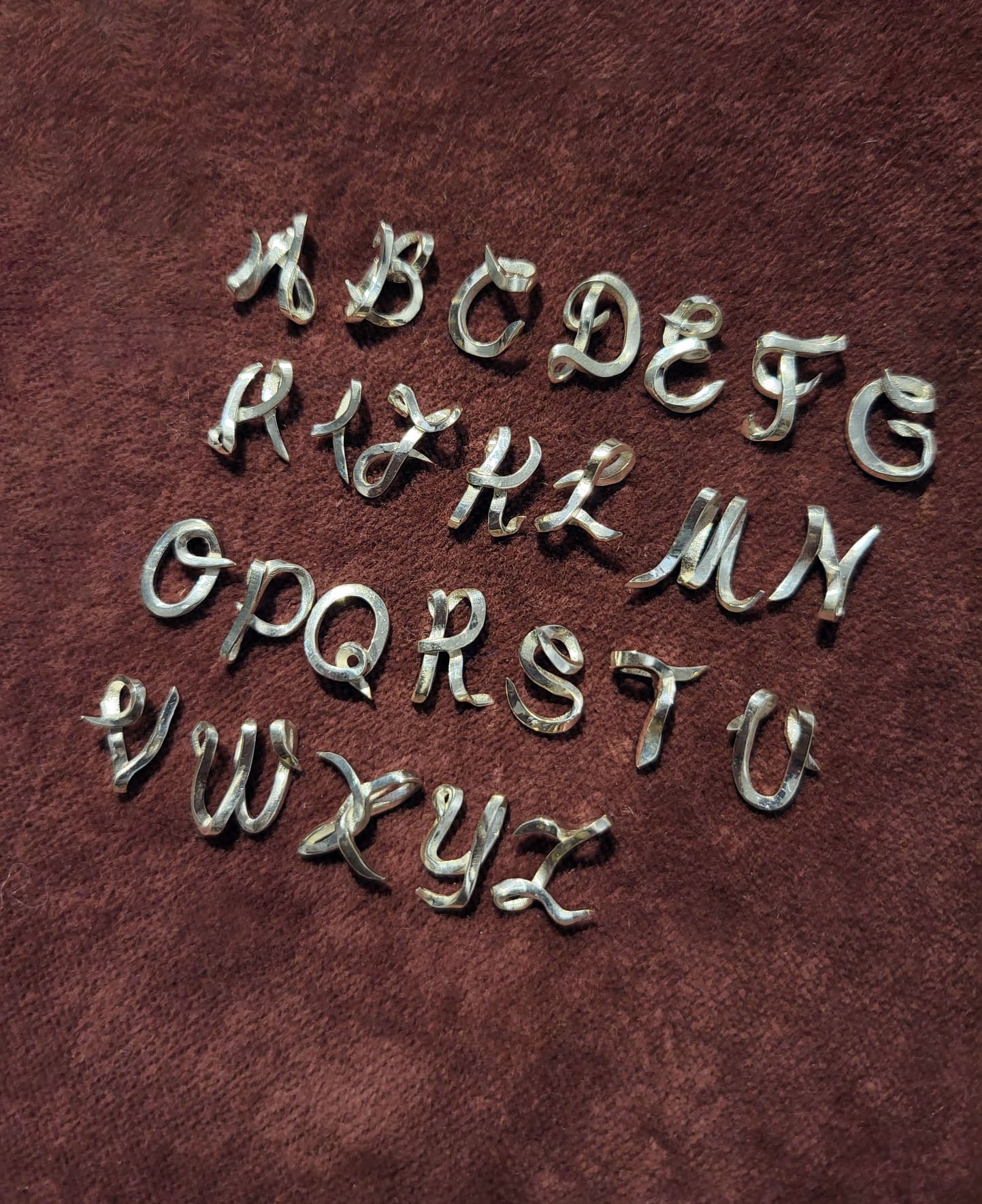handcrafted Silver letters on a red velvet background