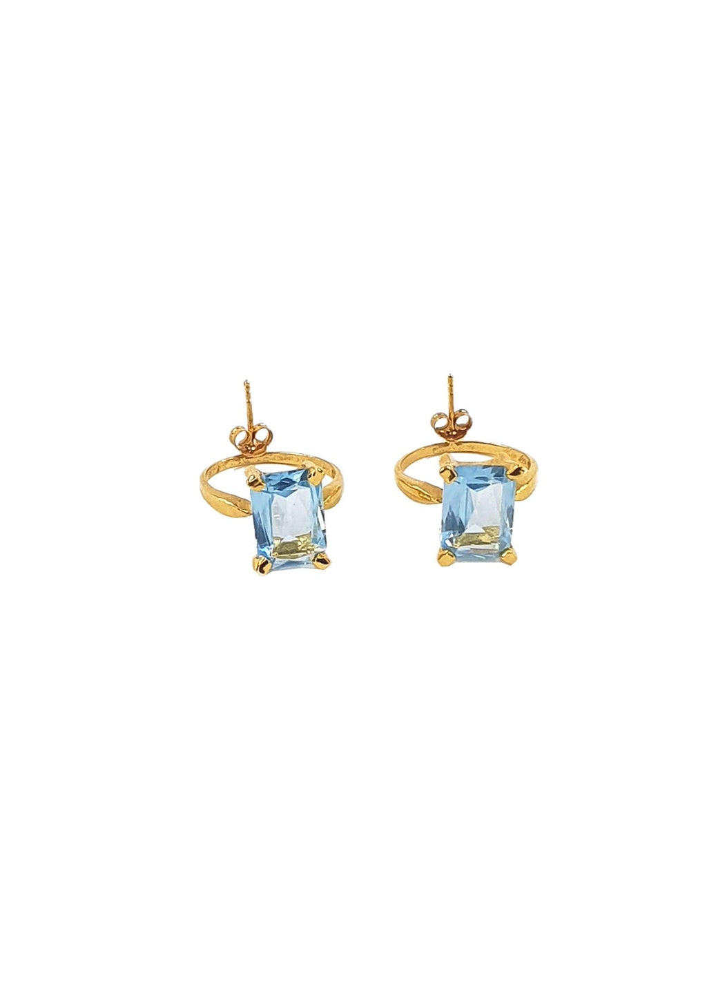 handcrafted Gold earrings with blue gemstones on a white background