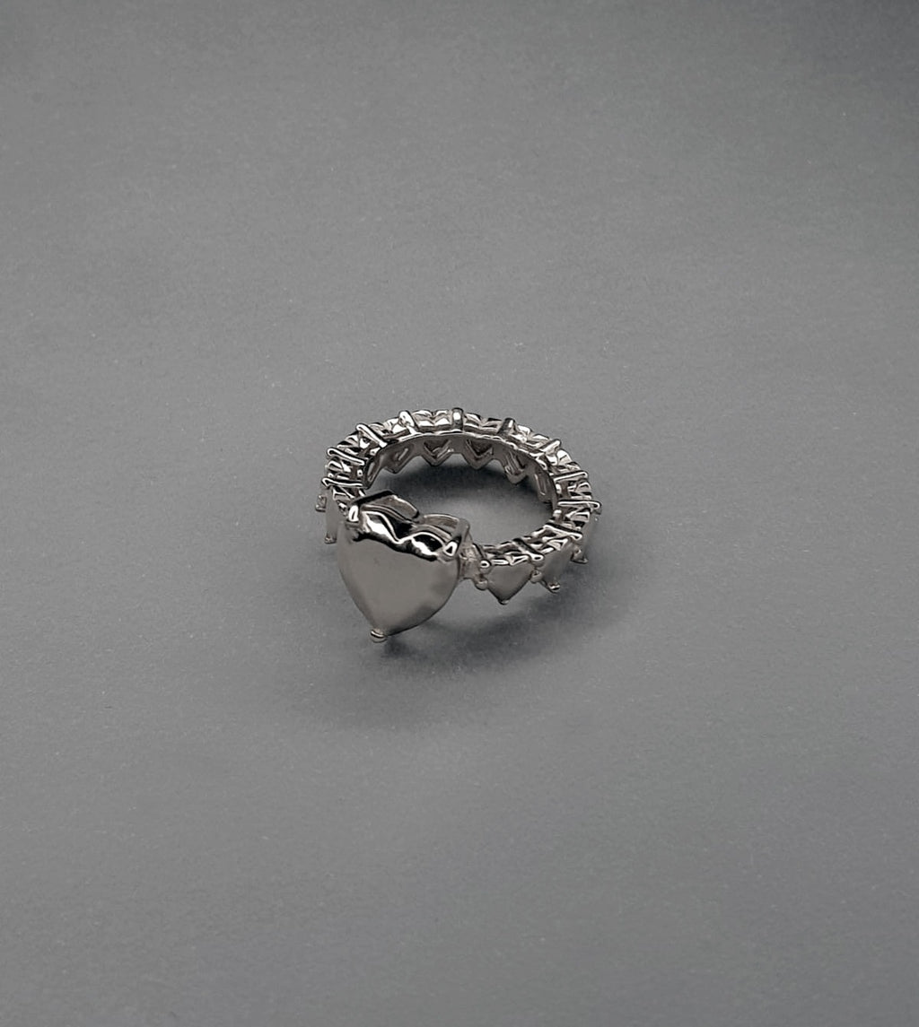 handcrafted Silver ring with heart designs on a gray background