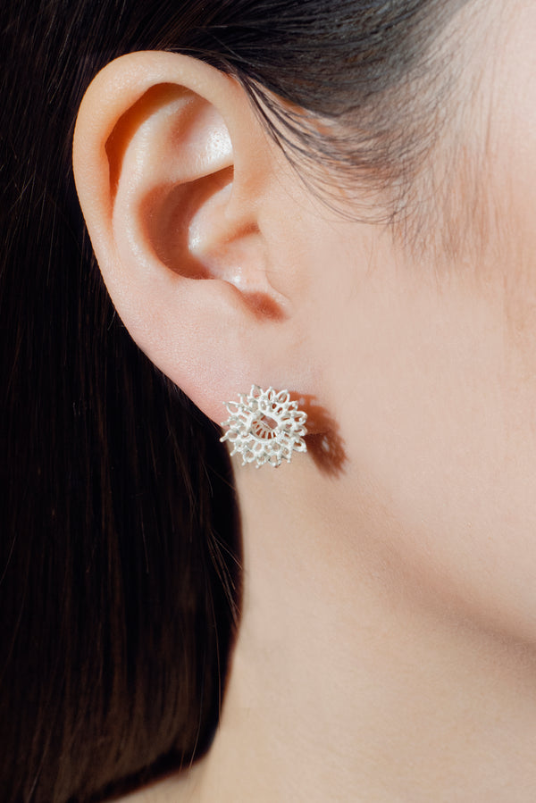 handcrafted silver earring worn by model
