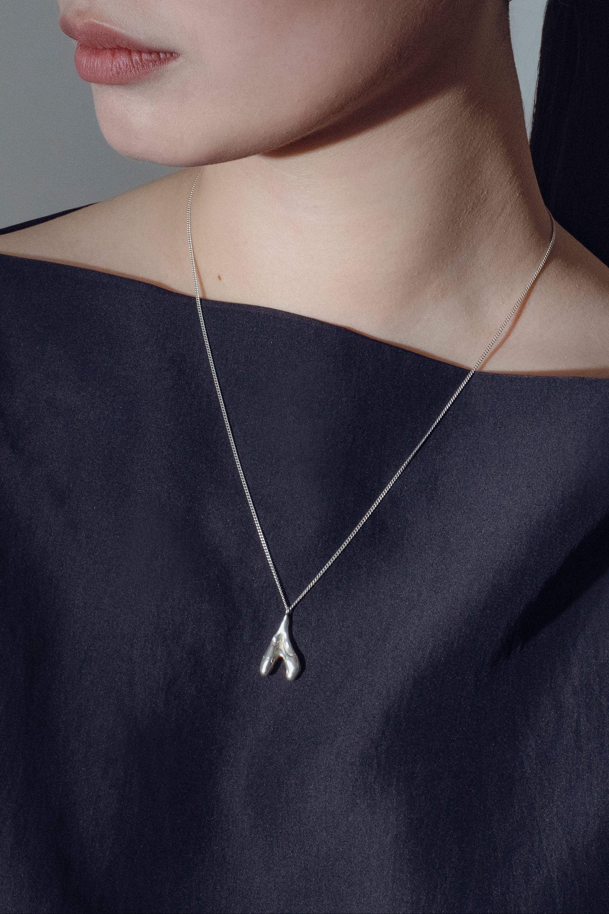 model wearing handcrafted silver Planta necklace